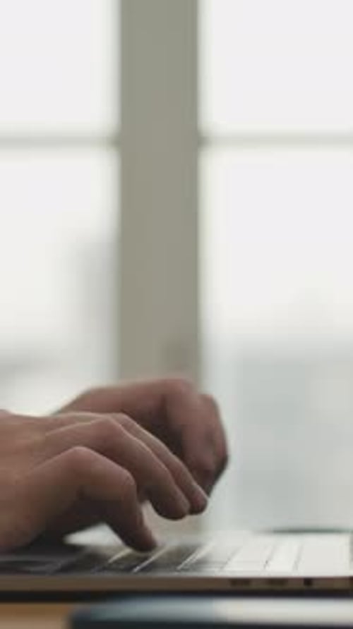 Hands of Business Man Typing Text on Keyboard of Laptop Computer in Work Office