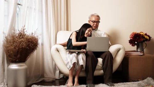 Grandfather and Granddaughter Enjoying Time with Technology