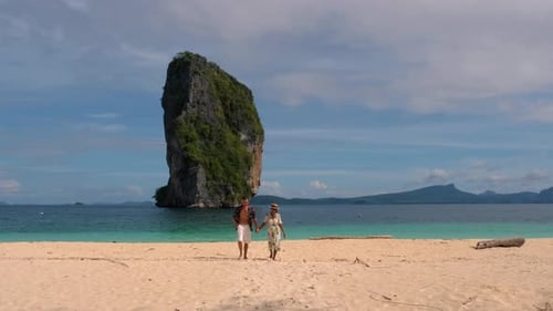 Couple Strolls on Serene Beach in Koh Poda Island Krabi Thailand During Golden Hour