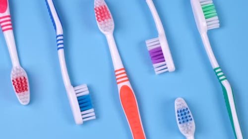 Background Dental Toothbrushes of Different Colors on a Blue Background Top View