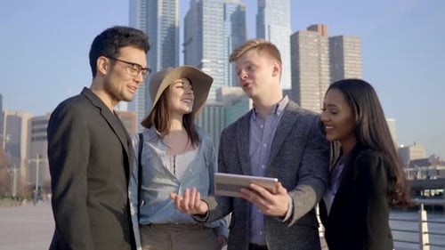 Friends Looking at Tablet in an Urban Setting