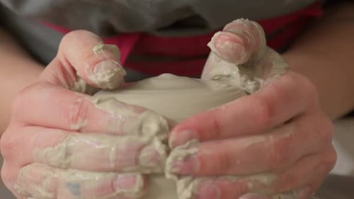 Close Up Hands Centering and Shaping Wet Clay on the Pottery Wheel