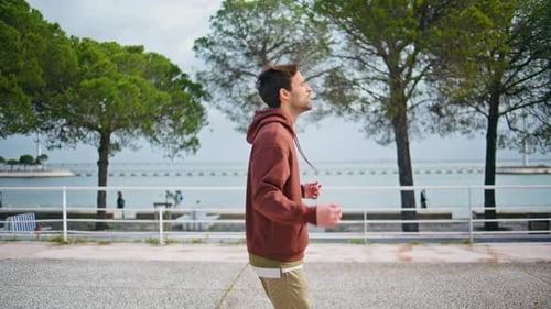 Fit Jogger Running Bay in Morning Sporty Man Jumping Warming Up Before Training