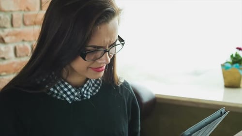 Young Woman Using Tablet Device Indoors