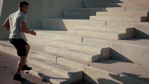 Man Running Up Concrete Stairs for Fitness
