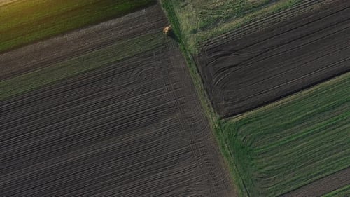 Village roads. Aerial top view of beautiful agricultural field at daytime. Rural landscape