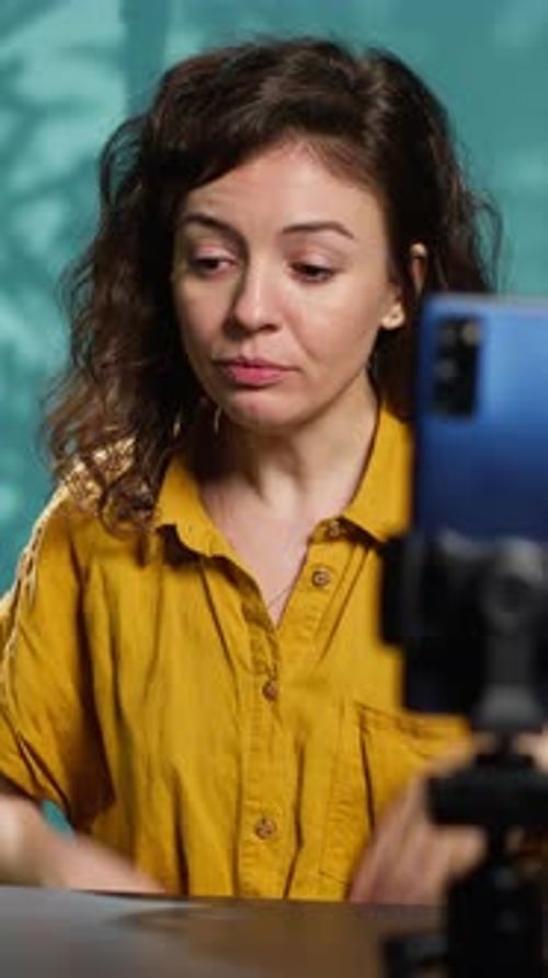 Vertical Video Content Creator Using Smartphone on Phone Holder to Shoot Intro for Vlog