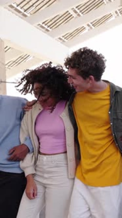 A Group of Young Multiethnic Friends Embracing Sharing a Fun Leisure Time While Walking the Street