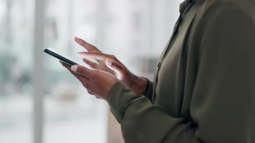 Hands Using a Mobile Phone Indoors