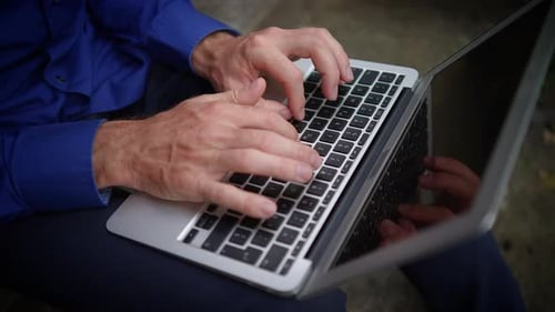 Hands Typing on a Laptop in Natural Light Highlighting Dedication and Engagement in Work