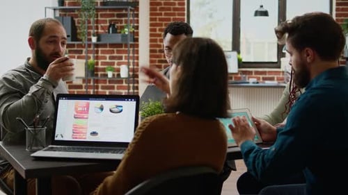 Diverse Team Collaborating on Data Analysis in Office