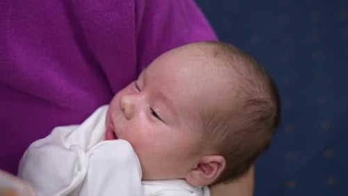 Loving Feeding of a Beautiful Baby Close Up