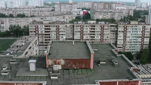 Residential buildings with football field in summer. Stock footage. Old residential buildings