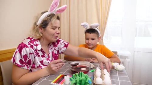 29 1. Mother and son celebrate Easter. They prepare a basket, paint eggs and have fun.