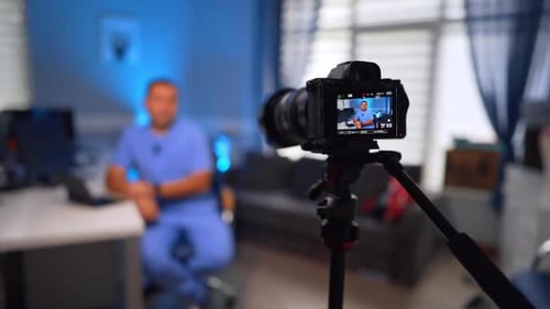 Man in Scrubs Being Filmed for a Video