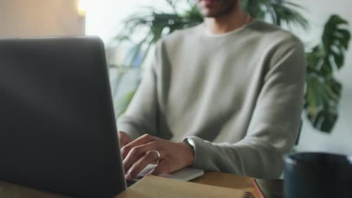 Man Working on Laptop in Home Office