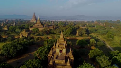 Explore the Enchanting Temples of Bagan Myanmar at Dawn Amidst Lush Landscapes