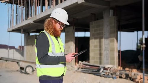 Construction Worker Using Tablet at Construction Site