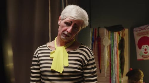 Worried Clown Posing in Costume with Clown Makeup