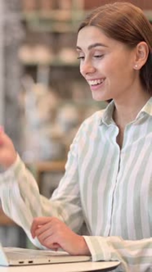 Sick Young Latin Woman with Laptop Coughing in Cafe, vertical video