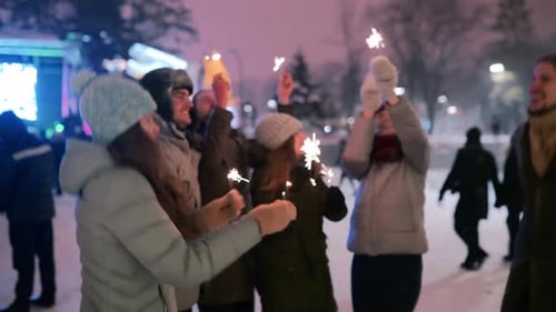 Friends Have Fun Partying with Sparklers and Doing Selfie Photo on Smartphone at Christmas Market