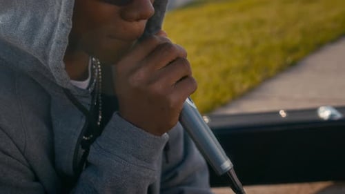 Black Male Street Musician Rapping in Public Space