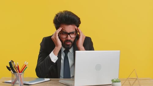 Tired Indian Business Man Suffering From Headache Problem Tension Migraine Stress at Home Office