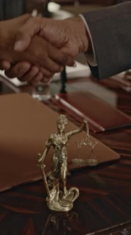 Vertical of Making Legal Agreement with Handshake over Themis Statue