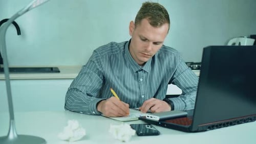 Frustrated Man Working from Home at Table