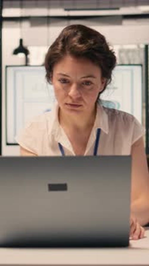 Vertical Video Portrait of Woman Opening Her Laptop and Solving Daily Tasks at Desk