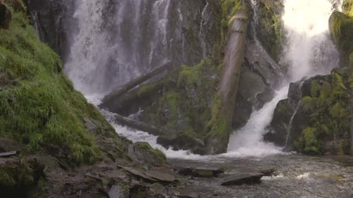 Beautiful waterfall in the southern Oregon cascades framed by green moss and vegetation, National Cr