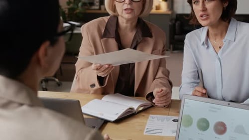 Female Office Manager Having Business Meeting with her Employees