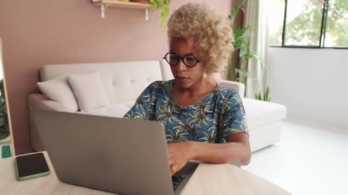 Woman Uses Laptop at Home During Daytime