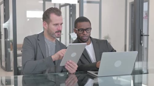 Mixed Race Teammates Working on Laptop