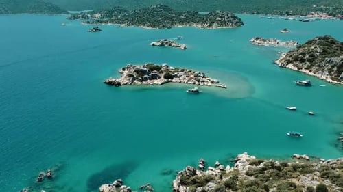 Rocky Islands with Green Vegetation and Boats in Turquoise Waters near Kekova