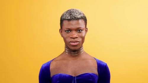 Androgynous Black Person Smiling Looking at the Camera