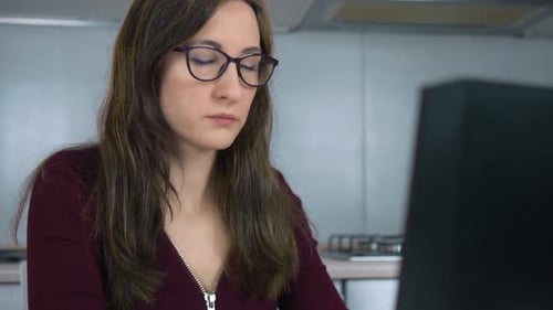 Woman Working at Computer Rubs Tired Eyes