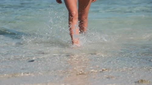 Woman Walking on the Beach Enjoying Summer Vacation
