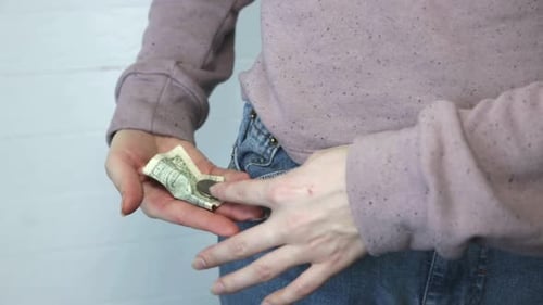 Person Taking Out Money from Jeans Pocket