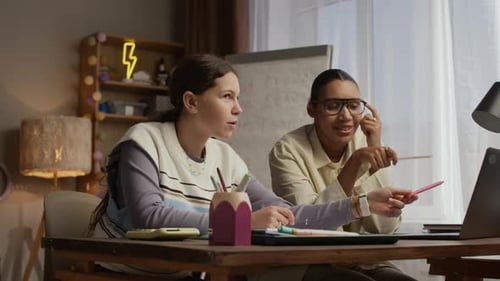 Girl and Woman Studying Together at Table Indoors