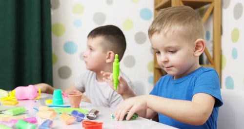 Children Playing with Colorful Modeling Clay Indoors