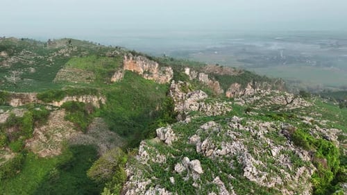 Drone footage of green rock hill landscape