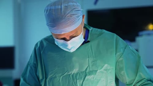 Plastic surgeon doing operation.