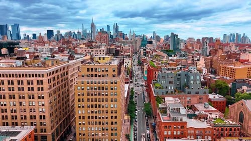 Transport moving by the straight busy street leading to the city downtown of New York, USA.