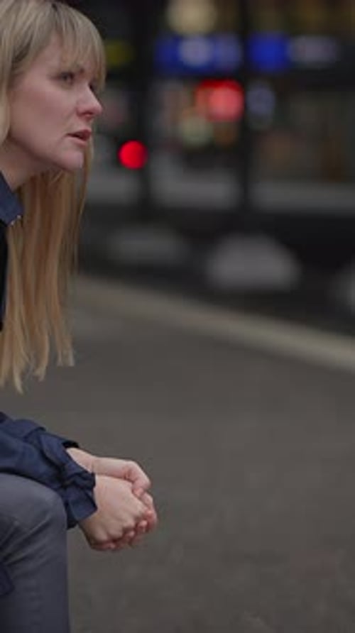 A Woman is Expressing Her Feelings of Distress Amidst the Bustling Environment of the City