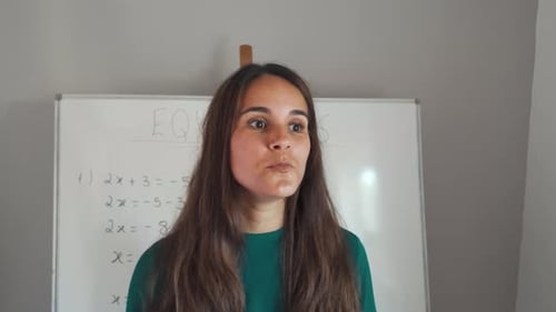 Woman Explains Math Equations on Whiteboard