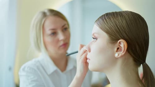 Makeup Artist Work in Her Beauty Studio Portrait of Woman Applying By Professional Make Up Master