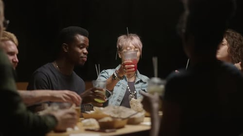 Friends Toasting Drinks at an Urban Restaurant
