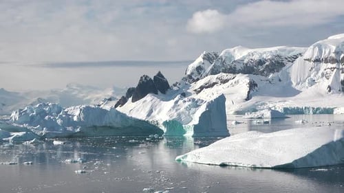 Exploring breathtaking icy landscapes filled with massive glaciers and serene waters in Antarctica.