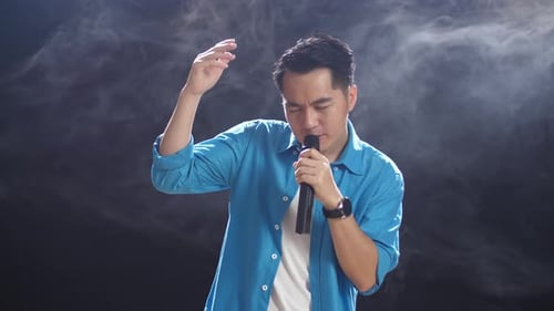 Young Adult Sings Passionately with a Microphone